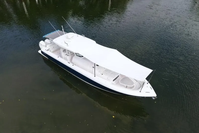  Yacht Photos Pics 2022 Intrepid 407 Panacea boat with canopy on calm water.