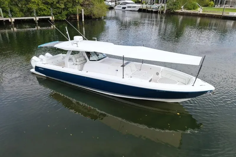  Yacht Photos Pics 2022 Intrepid 407 Panacea boat with canopy on calm water.