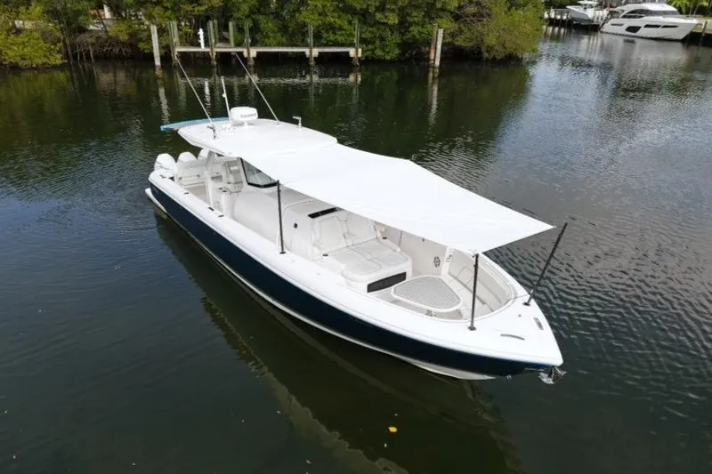  Yacht Photos Pics 2022 Intrepid 407 Panacea boat with canopy on calm water.