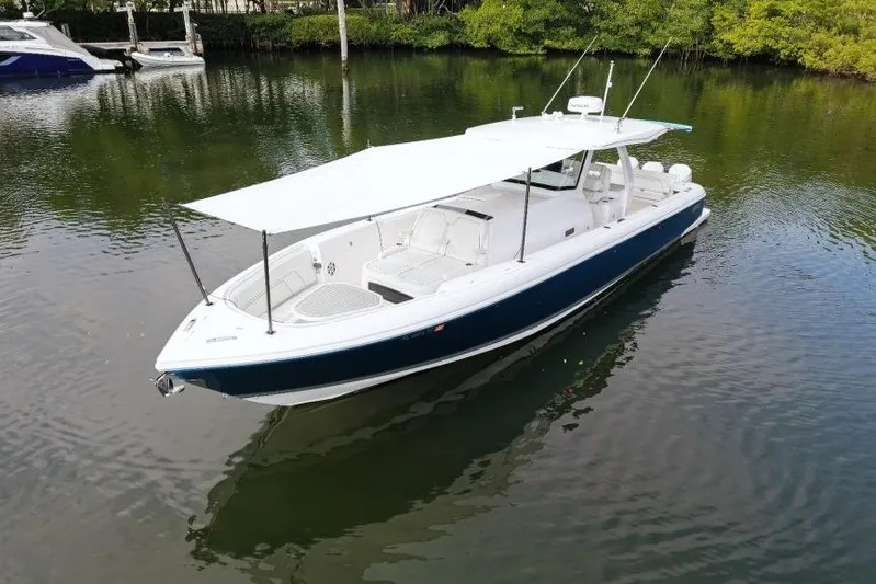  Yacht Photos Pics 2022 Intrepid 407 Panacea boat with canopy on calm water.