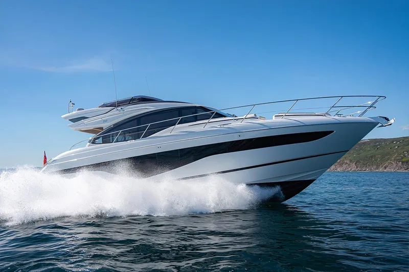  Yacht Photos Pics 2023 Princess S62 yacht cruising on open water under clear blue sky.