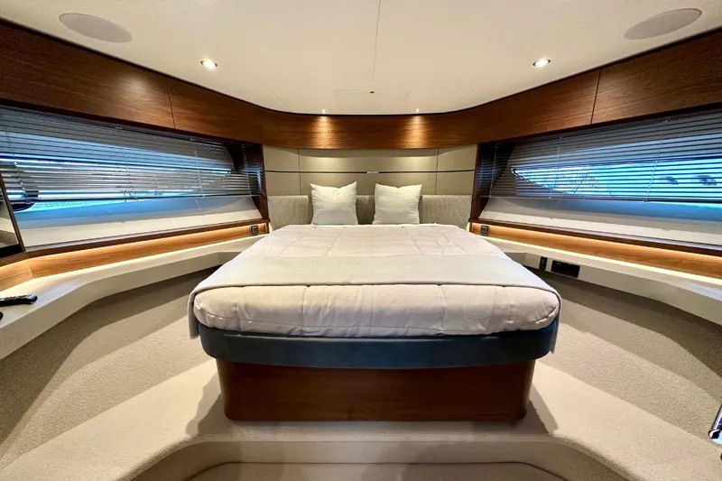  Yacht Photos Pics Luxurious 2023 Princess S62 yacht bedroom with modern design and elegant wood accents.