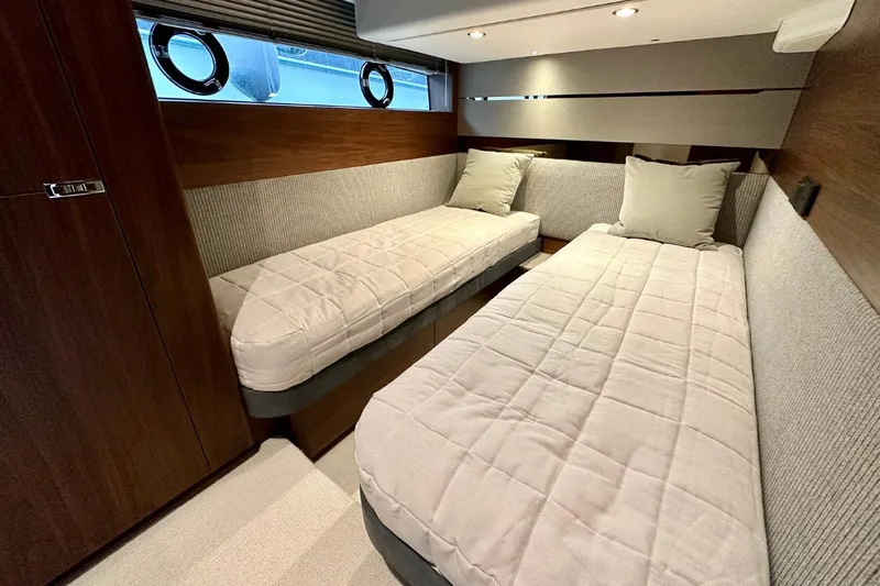  Yacht Photos Pics Luxurious 2023 Princess S62 yacht cabin with twin beds and modern decor.