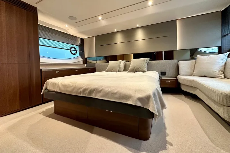  Yacht Photos Pics Luxurious 2023 Princess S62 yacht bedroom with elegant decor and modern furnishings.