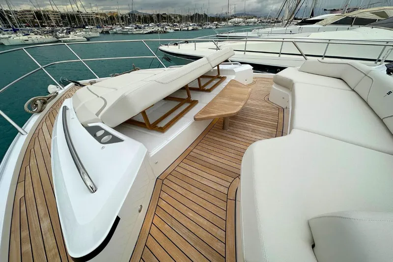  Yacht Photos Pics Luxurious 2023 Princess S62 yacht deck with elegant seating and wooden flooring.