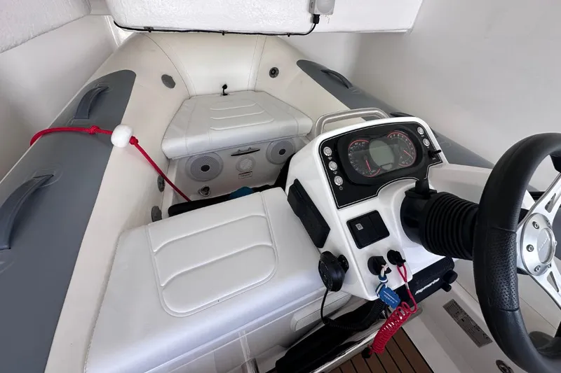  Yacht Photos Pics Interior of 2023 Princess S62 boat, featuring steering console and seating area.