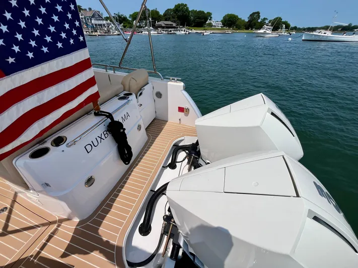 Waterlee Yacht Photos Pics 2019 MJM 35z boat with dual engines, American flag, docked in a scenic harbor.