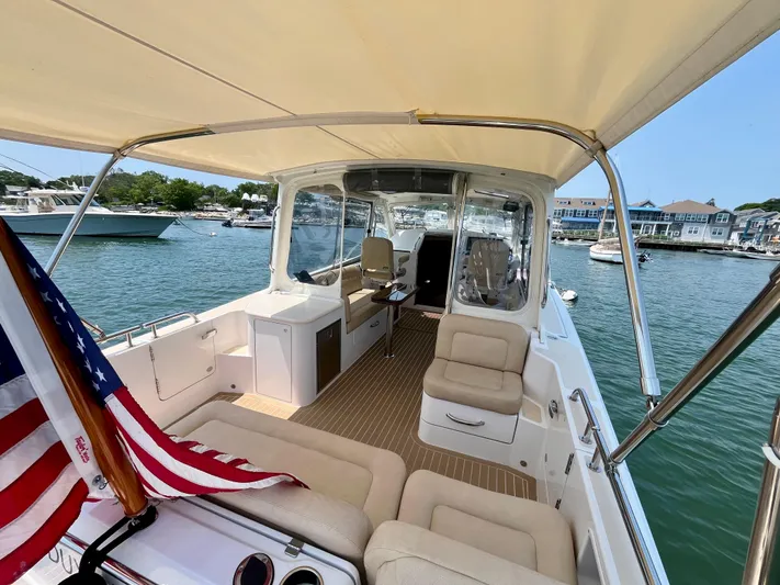 Waterlee Yacht Photos Pics 2019 MJM 35z boat interior with seating, American flag, and waterfront view.