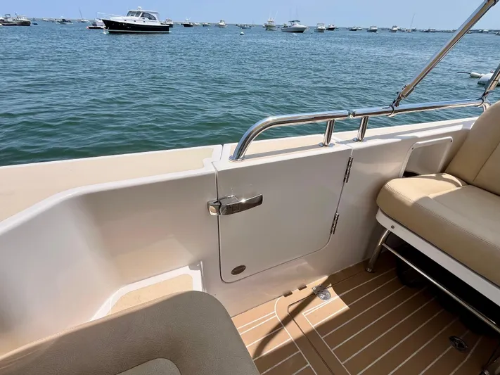 Waterlee Yacht Photos Pics 2019 MJM 35z boat interior with beige seating, overlooking a calm sea with distant boats.