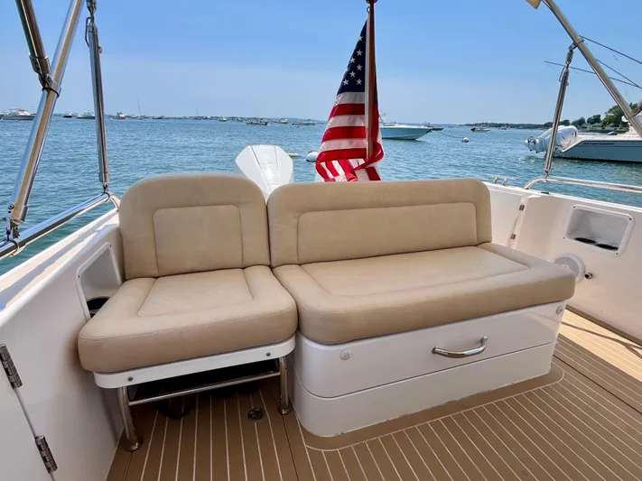 Waterlee Yacht Photos Pics 2019 MJM 35z boat with beige seating, American flag, and ocean view.