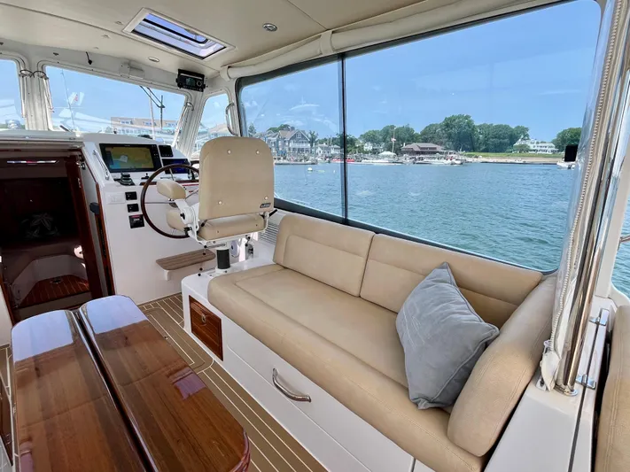 Waterlee Yacht Photos Pics Interior of 2019 MJM 35z yacht with seating, table, and waterfront view.
