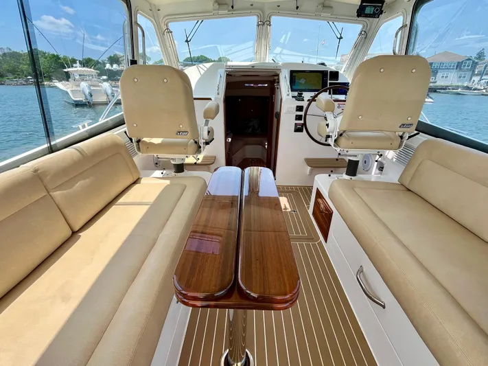 Waterlee Yacht Photos Pics Interior of 2019 MJM 35z boat with beige seating and wooden table.