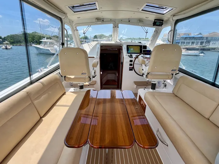 Waterlee Yacht Photos Pics Interior of a 2019 MJM 35z boat with luxurious seating and wooden table.
