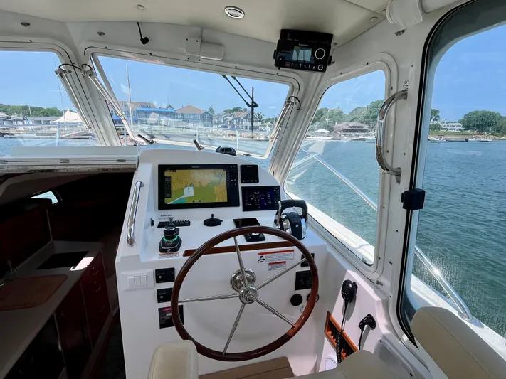 Waterlee Yacht Photos Pics Helm of 2019 MJM 35z boat with navigation equipment, overlooking marina and water.