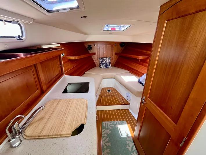 Waterlee Yacht Photos Pics Interior of 2019 MJM 35z boat with wood finish and compact kitchen area.