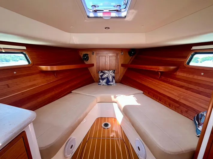 Waterlee Yacht Photos Pics Interior of 2019 MJM 35z boat with wooden paneling and beige seating.