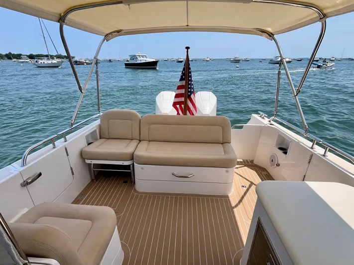 Waterlee Yacht Photos Pics 2019 MJM 35z boat interior with beige seating, American flag, and ocean view.