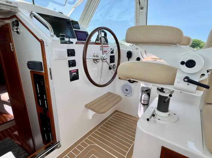 Waterlee Yacht Photos Pics Helm of 2019 MJM 35z boat with steering wheel and navigation controls.