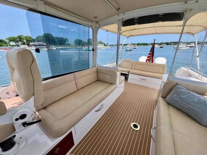 Waterlee Yacht Photos Pics Luxurious 2019 MJM 35z boat interior with beige seating and scenic waterfront view.