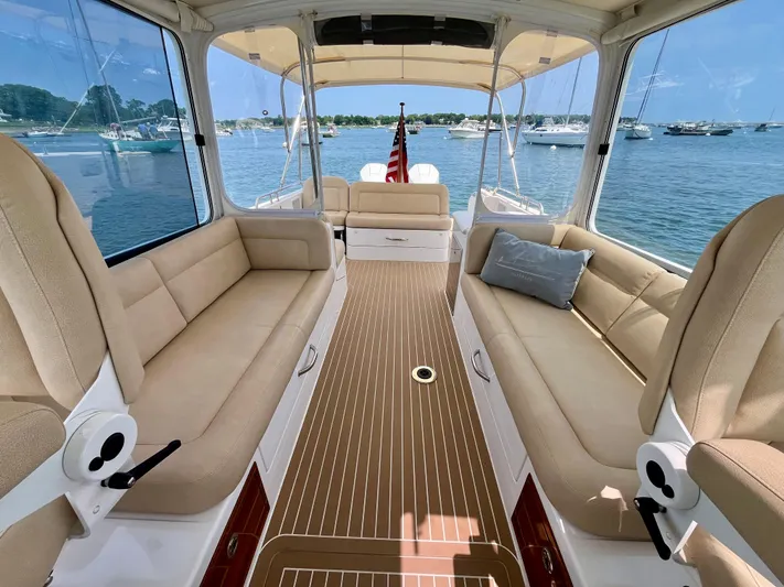 Waterlee Yacht Photos Pics 2019 MJM 35z boat interior with beige seating, wooden flooring, and scenic water view.