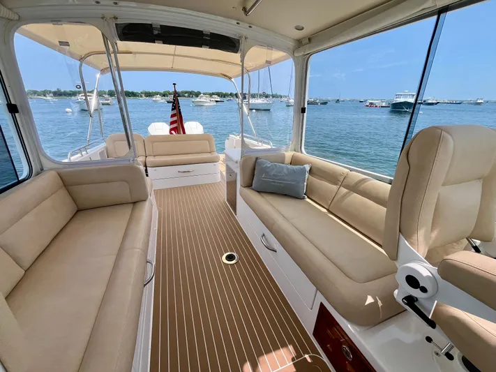 Waterlee Yacht Photos Pics 2019 MJM 35z yacht interior with beige seating, wooden flooring, and scenic water view.