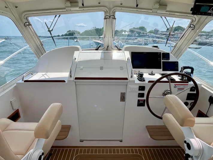 Waterlee Yacht Photos Pics Interior view of 2019 MJM 35z boat cockpit with dual seats and navigation controls.