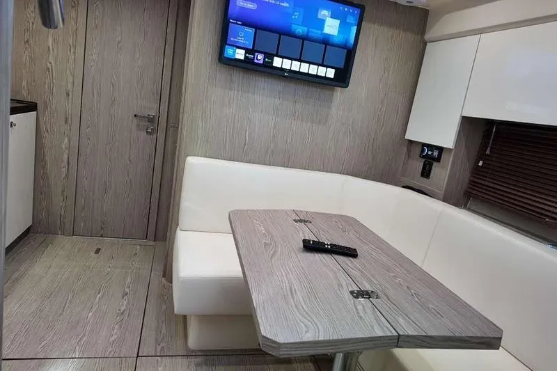  Yacht Photos Pics Interior of 2024 Sessa Marine C44 Cruiser with modern seating and wall-mounted TV.