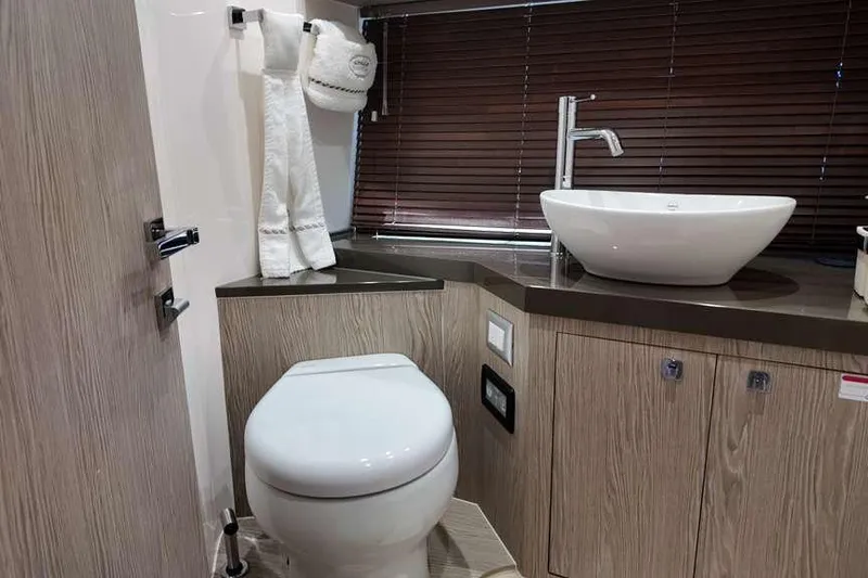  Yacht Photos Pics Luxurious bathroom in 2024 Sessa Marine C44 Cruiser with modern fixtures and elegant design.