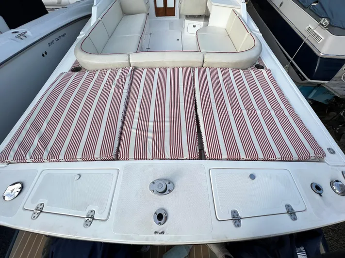  Yacht Photos Pics 2015 Hunt Yachts Harrier Sport with striped cushions and spacious seating area.