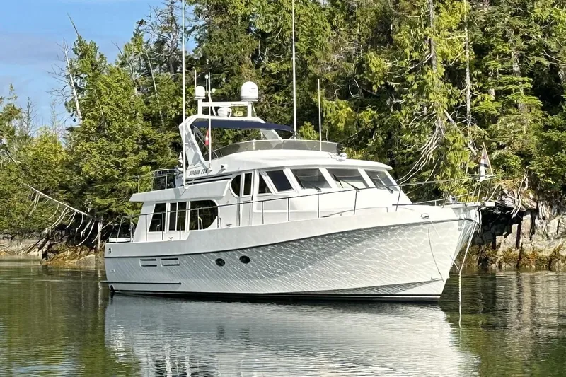 Moore Fun Yacht Photos Pics 1998 Ocean Alexander 486 Classico Pilothouse yacht anchored in serene forested waters.