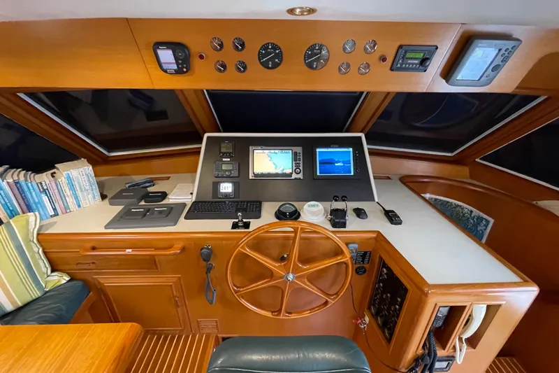 Moore Fun Yacht Photos Pics 1998 Ocean Alexander 486 Classico Pilothouse helm with navigation equipment and wooden steering wheel.