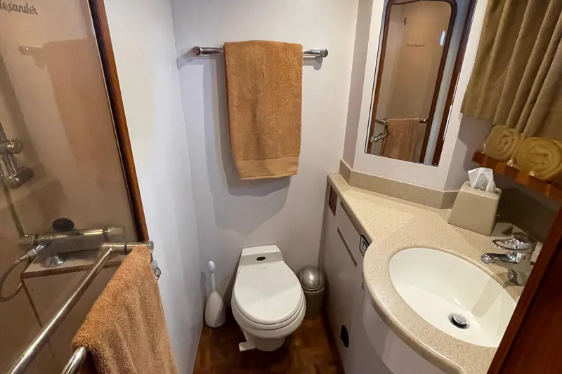 Moore Fun Yacht Photos Pics Bathroom interior of 1998 Ocean Alexander 486 Classico Pilothouse yacht, featuring sink and shower.