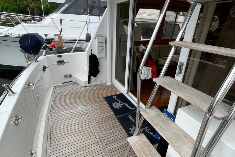 Moore Fun Yacht Photos Pics 1998 Ocean Alexander 486 Classico Pilothouse yacht deck with wooden flooring and stairs.