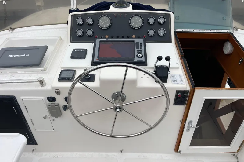 Moore Fun Yacht Photos Pics 1998 Ocean Alexander 486 Classico Pilothouse helm with navigation equipment and steering wheel.