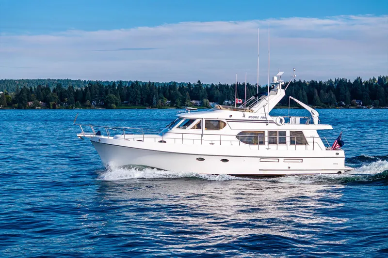 Moore Fun Yacht Photos Pics Ocean Alexander 486 Classico Pilothouse yacht cruising on a serene lake, 1998 model.
