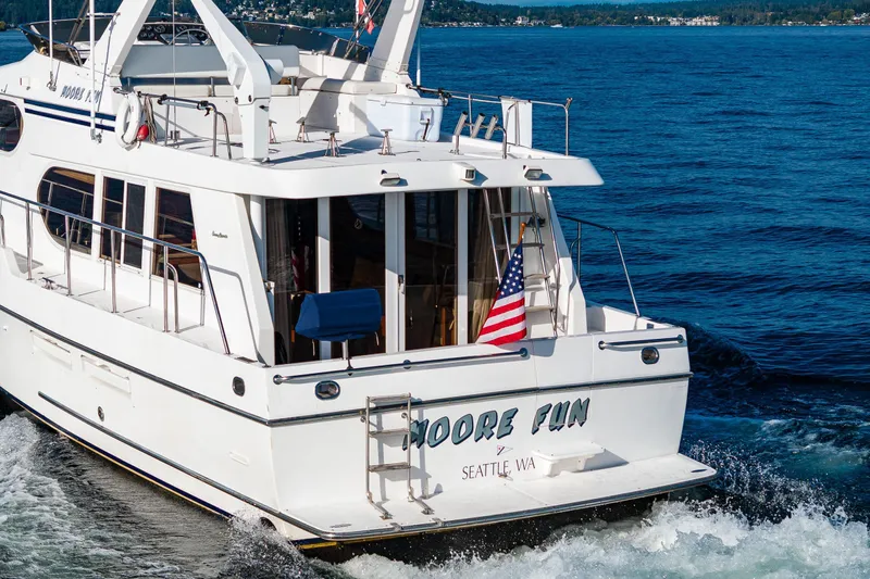 Moore Fun Yacht Photos Pics Ocean Alexander 486 Classico Pilothouse yacht cruising, 1998 model, with American flag, Seattle waters.