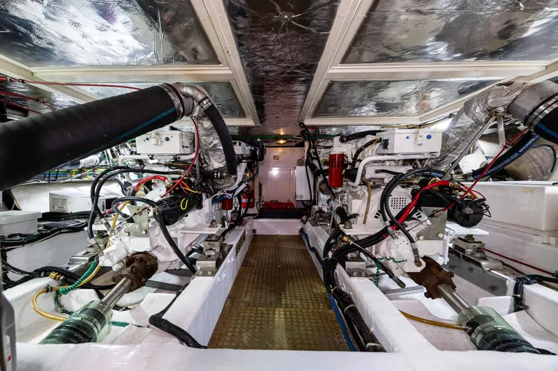 Moore Fun Yacht Photos Pics Engine room of 1998 Ocean Alexander 486 Classico Pilothouse, showcasing dual engines and mechanical systems.