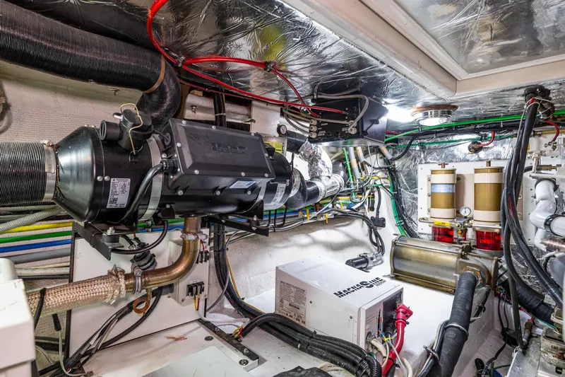 Moore Fun Yacht Photos Pics Engine room of 1998 Ocean Alexander 486 Classico Pilothouse, showcasing mechanical systems and wiring.