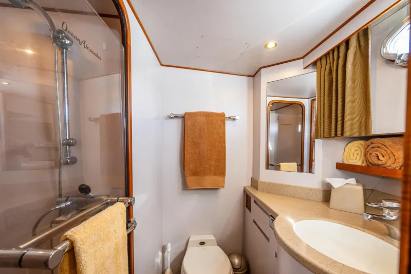 Moore Fun Yacht Photos Pics Luxurious bathroom in 1998 Ocean Alexander 486 Classico Pilothouse yacht, featuring shower and vanity.