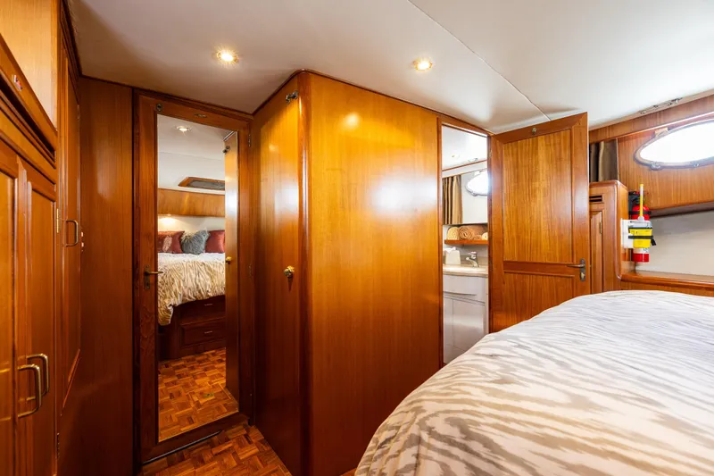 Moore Fun Yacht Photos Pics Luxurious 1998 Ocean Alexander 486 Classico Pilothouse interior with wood paneling and cozy bedroom.