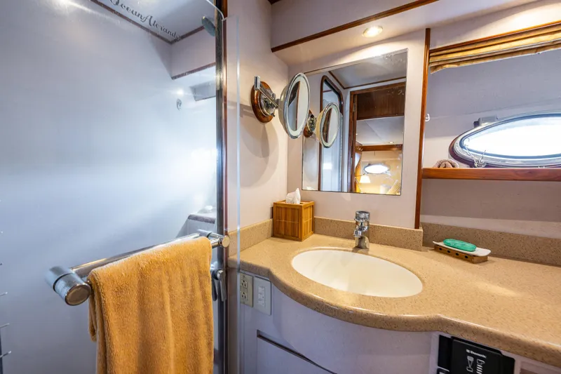 Moore Fun Yacht Photos Pics Bathroom interior of 1998 Ocean Alexander 486 Classico Pilothouse yacht, featuring sink and mirror.