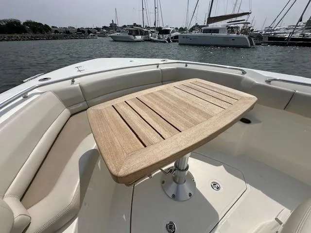 Boston Whaler 330 Outrage Yacht Photos Pics 2016 Boston Whaler 330 Outrage boat with wooden table, docked in marina.