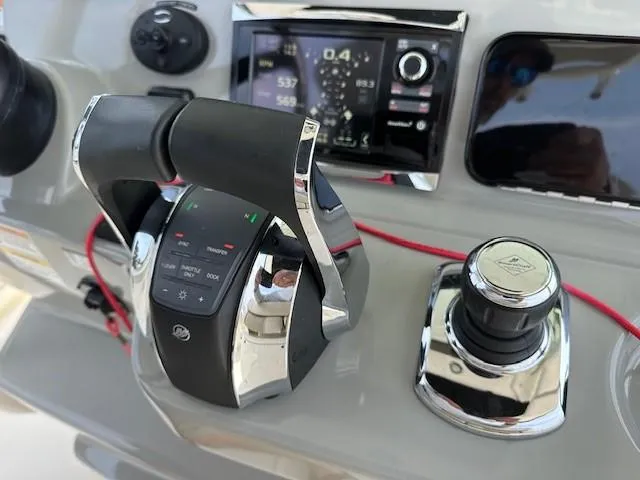 Boston Whaler 330 Outrage Yacht Photos Pics Control panel of a 2016 Boston Whaler 330 Outrage boat with throttle and joystick.