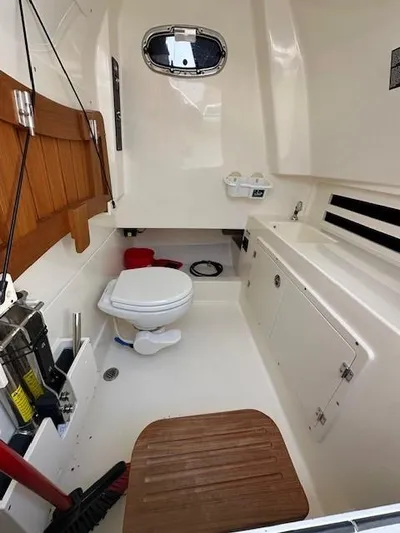 Boston Whaler 330 Outrage Yacht Photos Pics 2016 Boston Whaler 330 Outrage cabin interior with toilet and storage.