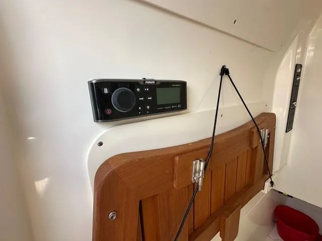 Boston Whaler 330 Outrage Yacht Photos Pics Boston Whaler 330 Outrage 2016 interior with Fusion audio system and wooden panel.