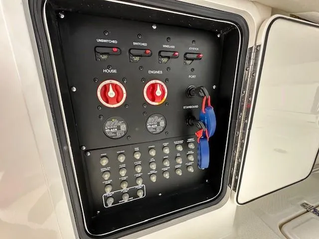 Boston Whaler 330 Outrage Yacht Photos Pics Control panel of a 2016 Boston Whaler 330 Outrage boat, featuring switches and dials.