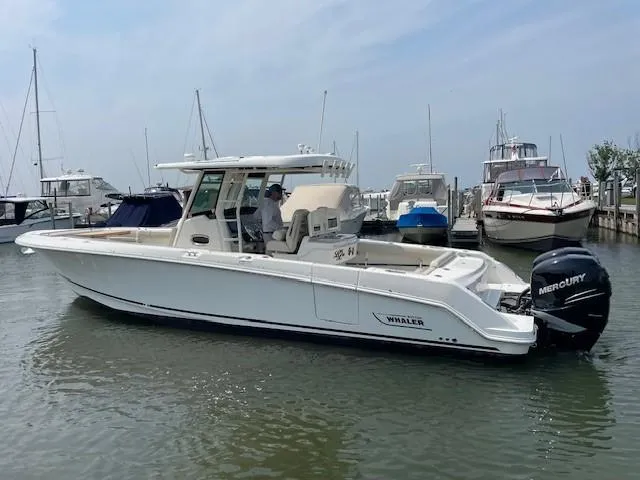 Boston Whaler 330 Outrage Yacht Photos Pics 2016 Boston Whaler 330 Outrage boat docked in a marina with other vessels.