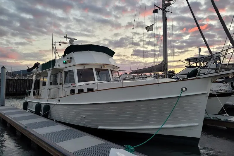 Goodlife Yacht Photos Pics 1998 Grand Banks 46 Europa yacht docked at sunset with colorful sky.