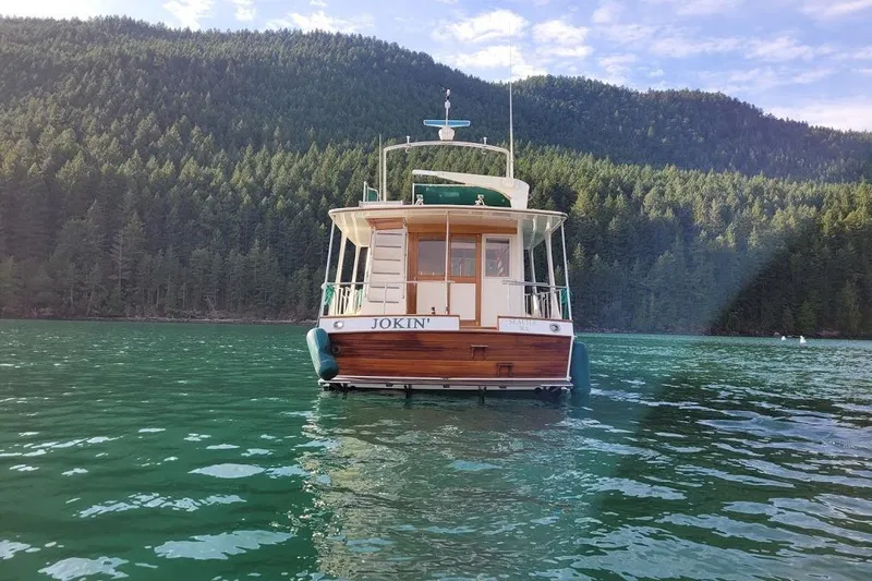 Goodlife Yacht Photos Pics Grand Banks 46 Europa 1998 yacht on serene lake with forested backdrop.