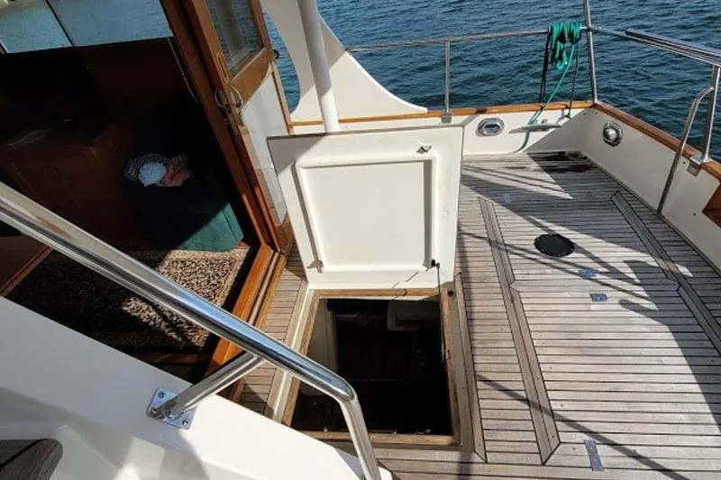 Goodlife Yacht Photos Pics 1998 Grand Banks 46 Europa yacht deck with open hatch and wooden flooring.